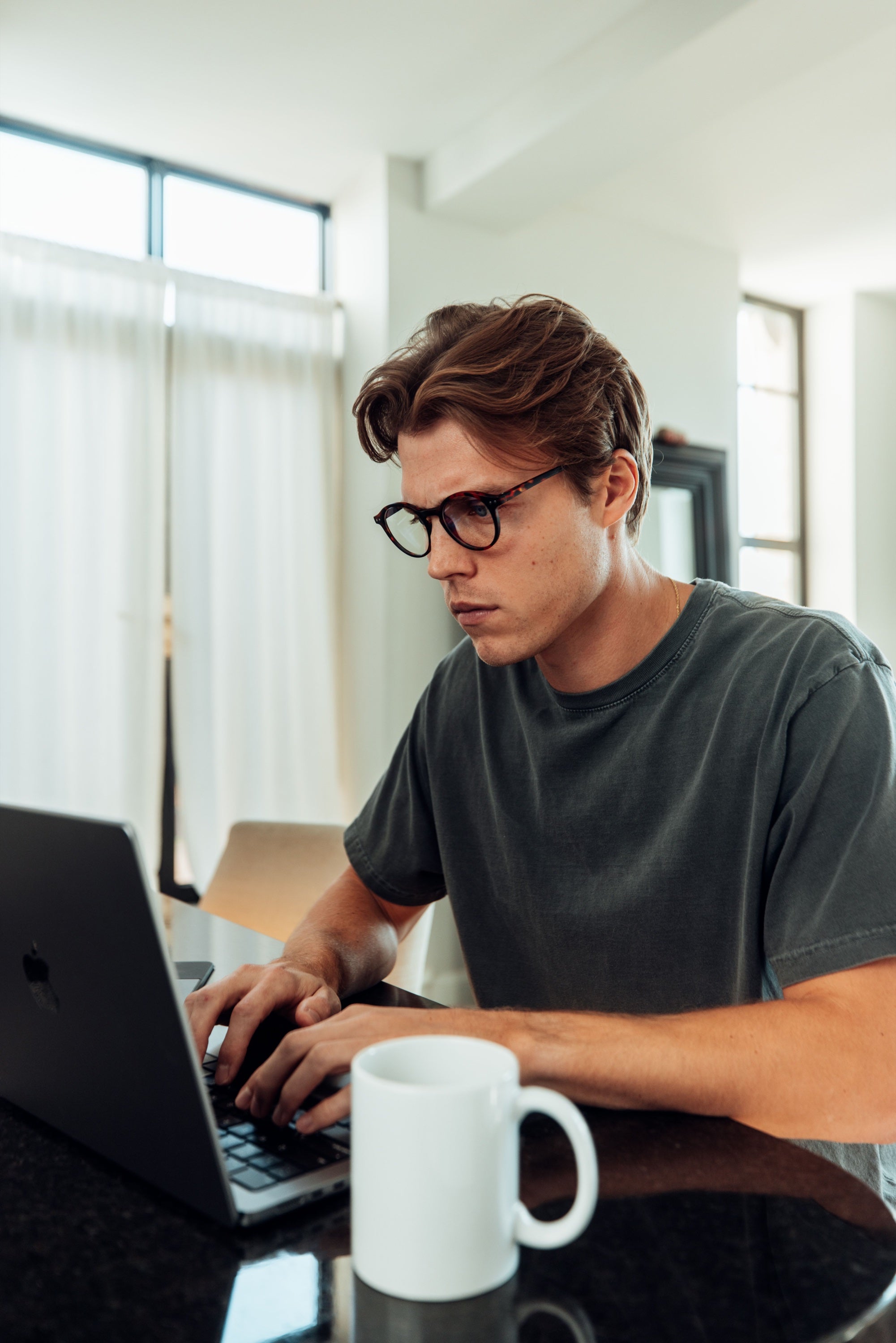 Gamer wearing Bye Blue Light glasses at a computer